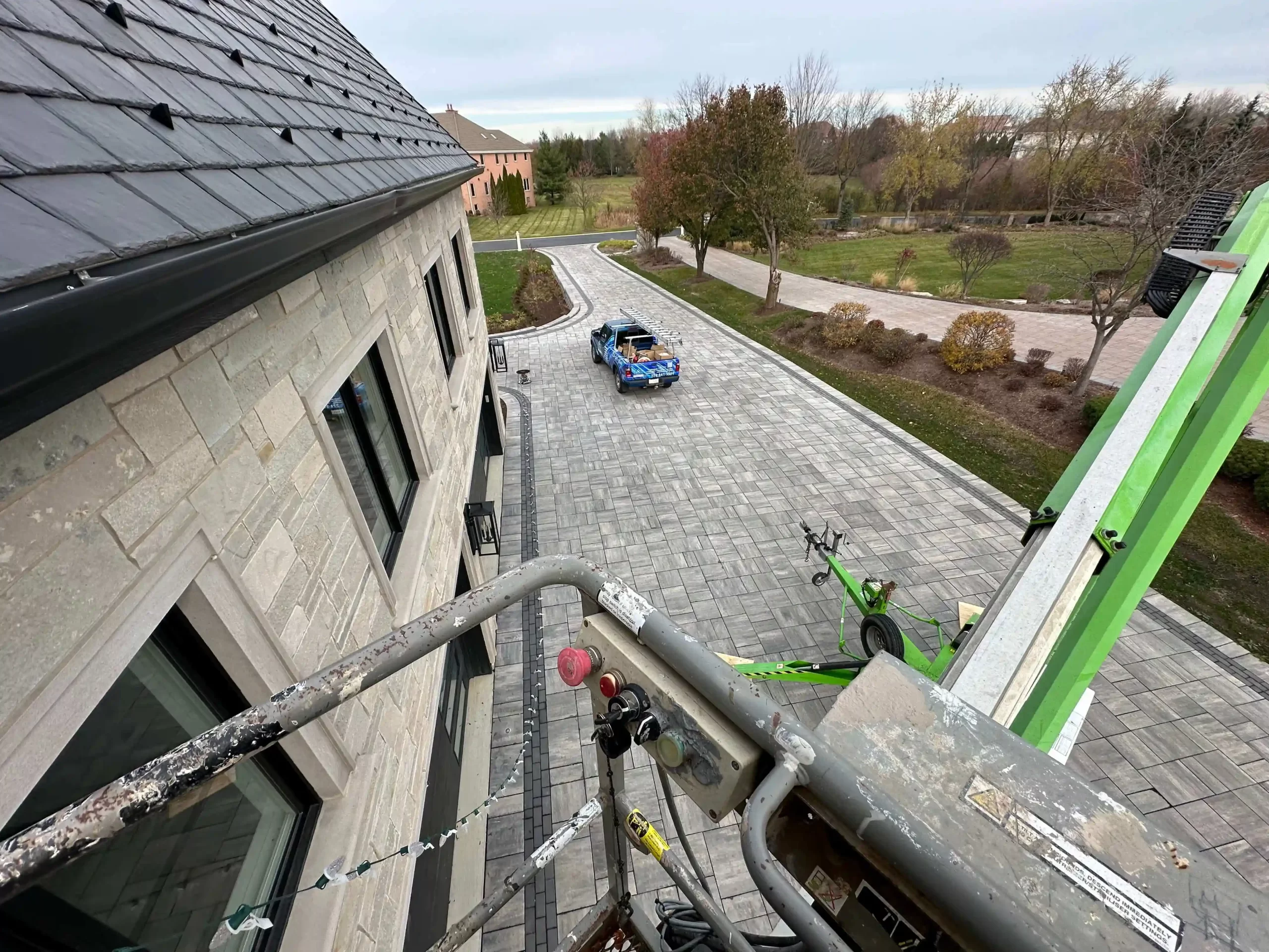 Crew installing holiday roofline lights on a North Chicagoland home